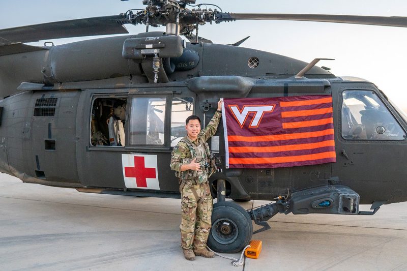 U.S. Army Capt. William Chung '15 stands with an HH-60M Blackhawk.